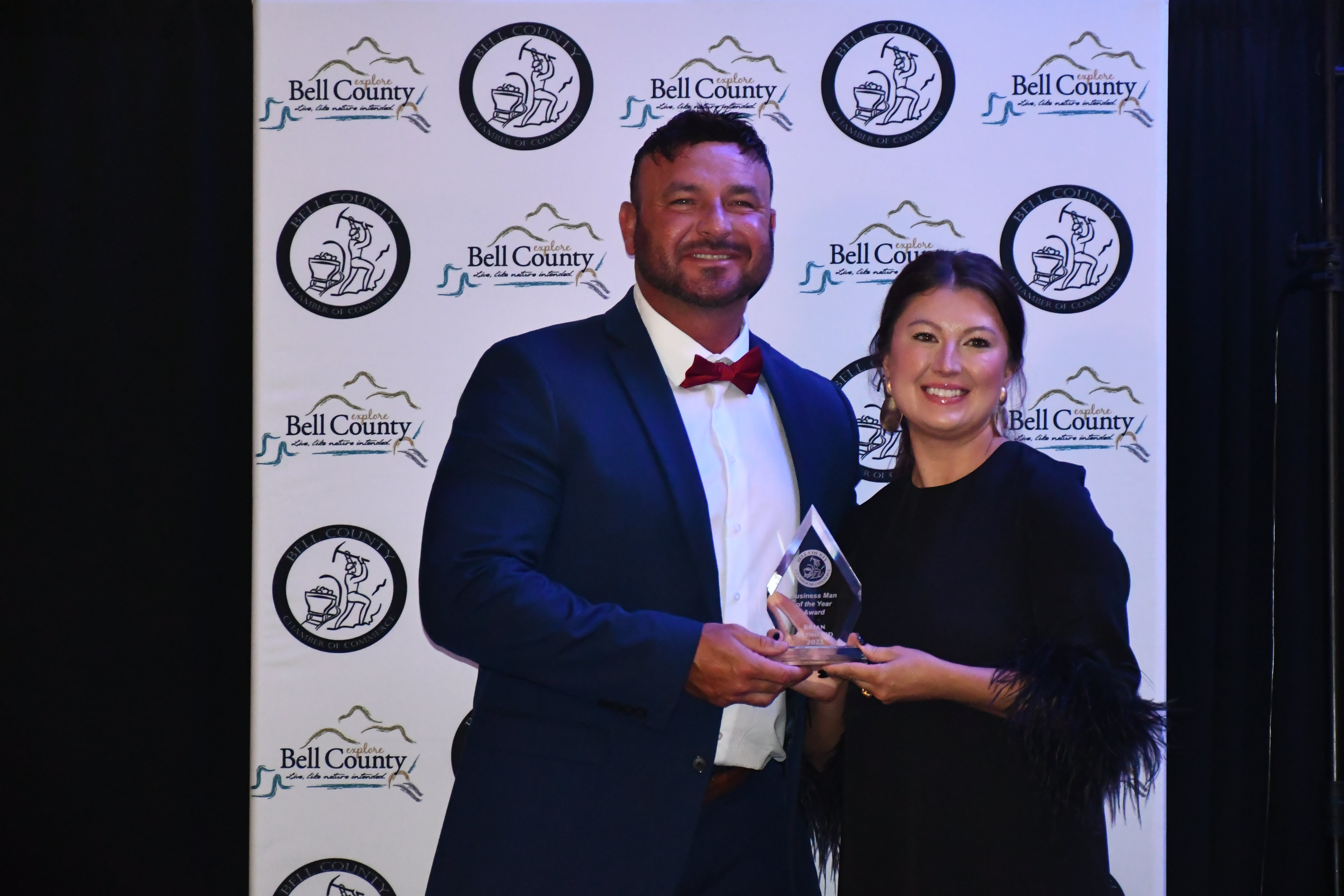 BUSINESSMAN OF THE YEAR AWARD WINNER BRIAN REDMOND (LEFT) OF SHORT-REDMOND AUTO GROUP WITH CHAMBER OF COMMERCE DIRECTOR MELISSA TURNER (RIGHT)